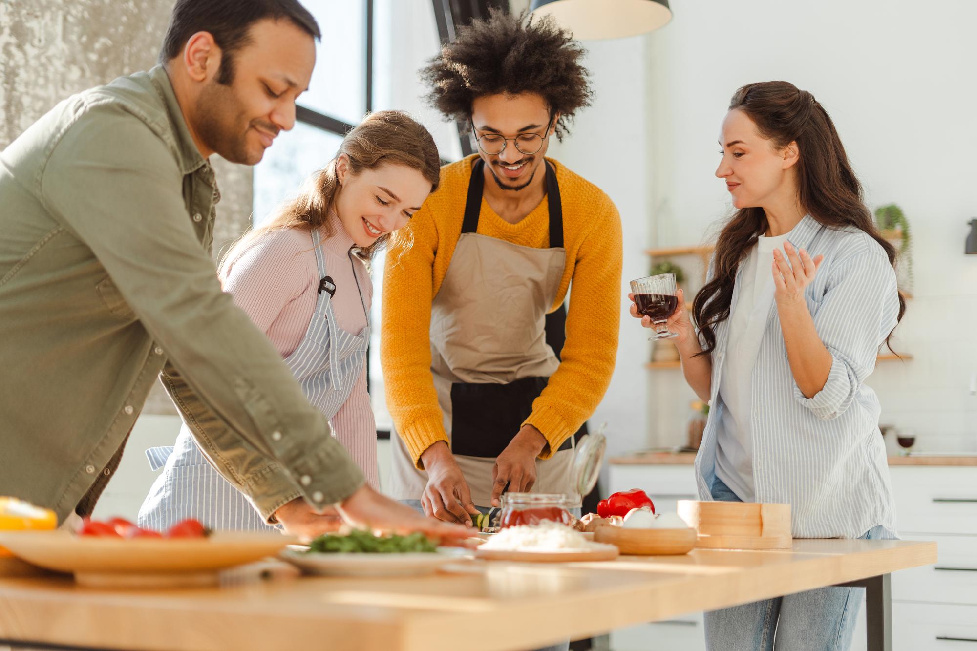 Workshop group smiling around a kitchen island